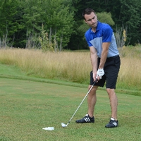 An alumnus golfing at The Meadows Golf Course.